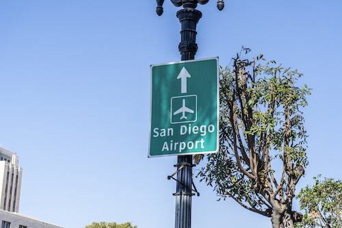 Green Sign on Lamp Post Directing to San Diego Airport